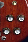 1962 Epiphone Newport Deluxe bass. Body detail - volume and tone knobs, input jack