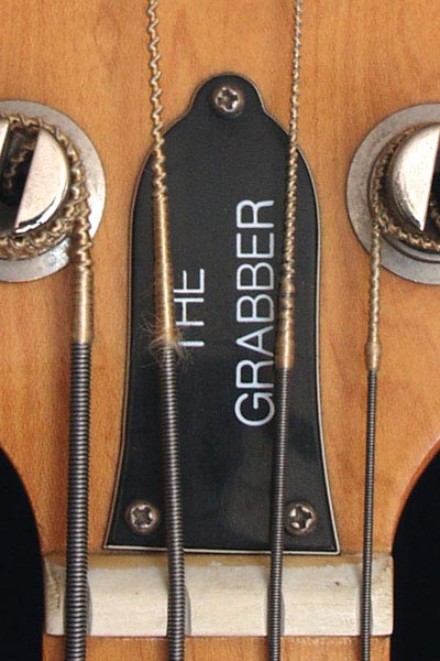 1977 Gibson Grabber bass. Truss rod cover. Note that it has three screws, rather than the usual two.