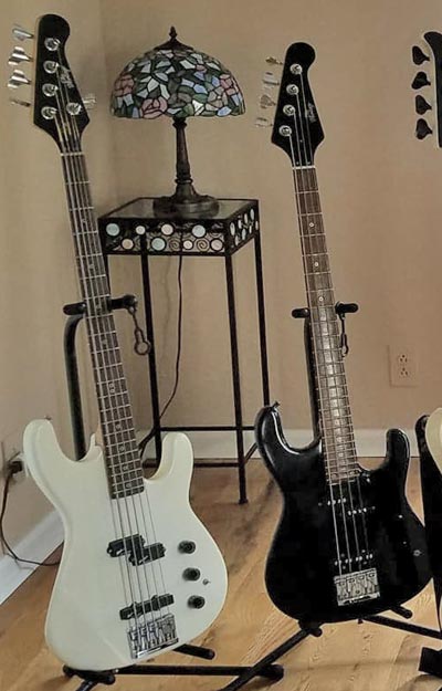 Two basses based on the Heritage HB-2: the five-string and the two octave medium-scale